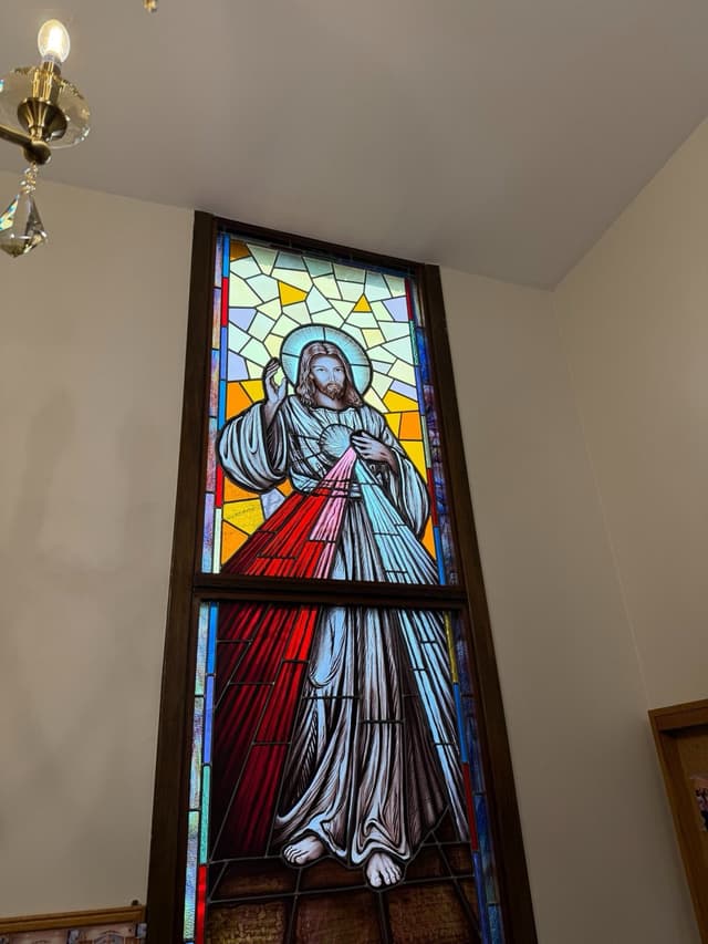 Stained glass window of Divine Mercy Jesus with red and white rays